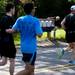 A resident grabs his morning newspaper as participants race by during the Dexter-Ann Arbor Run on Sunday, June 2. Daniel Brenner I AnnArbor.com